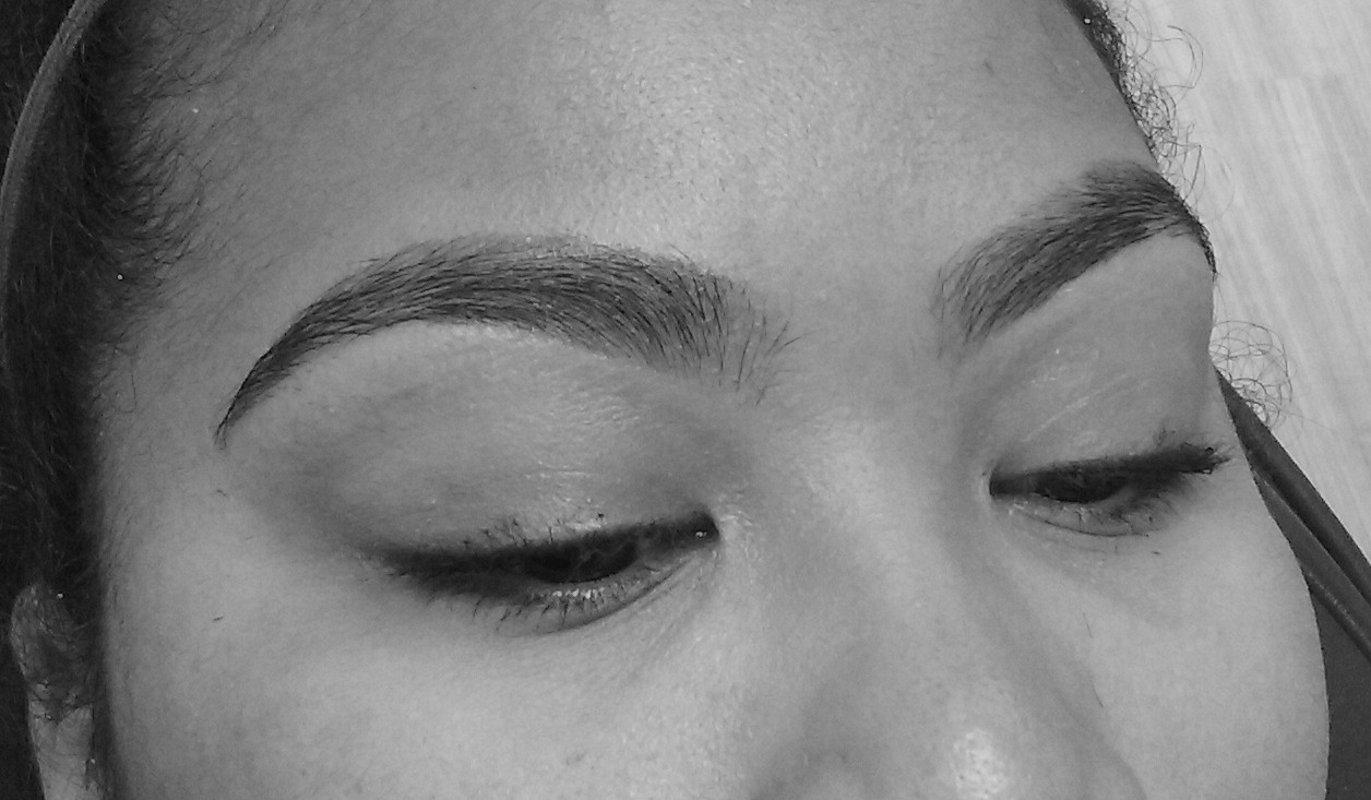 Real BROWDOC client with both eyebrows shaped into balanced natural arches