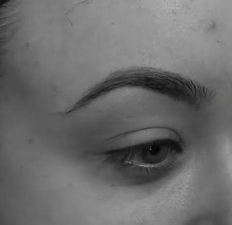 Close-up of a real BROWDOC client’s defined eyebrow and clean tapered edge